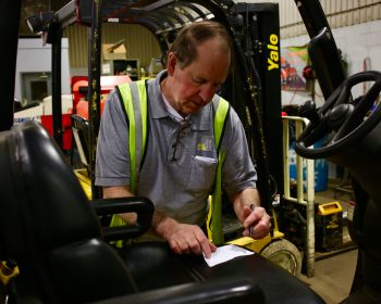 Person servicing a forklift