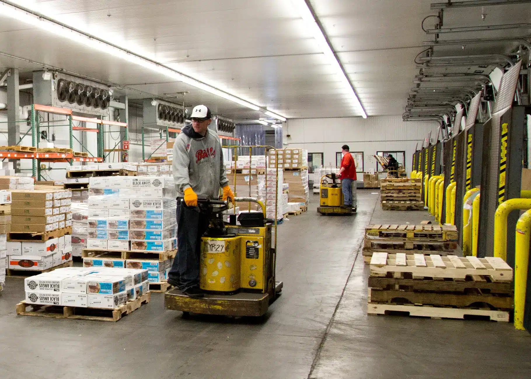 Person operating a Yale pallet jack in a warehouse