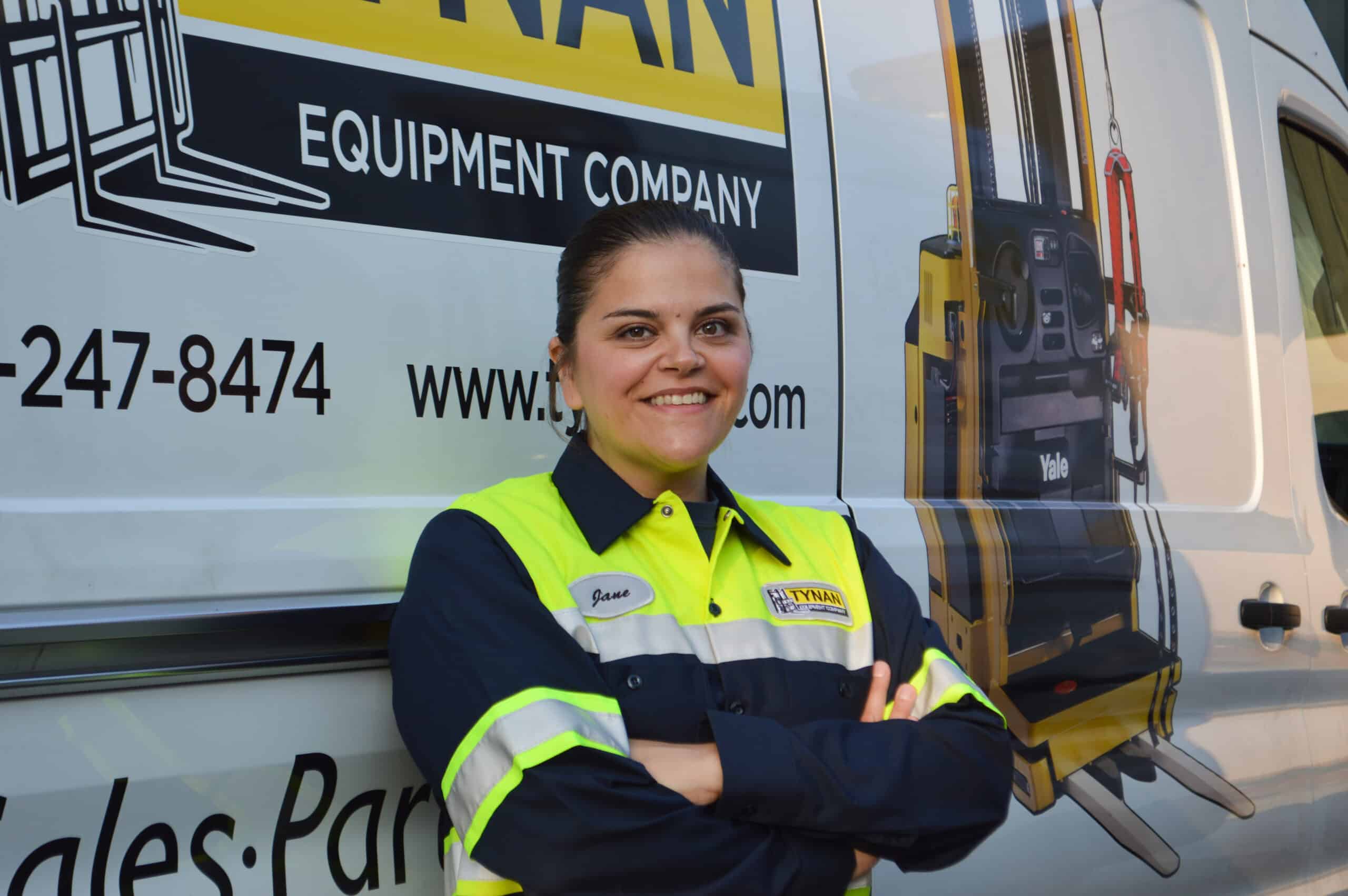 Tynan employee standing in front of a Tynan truck