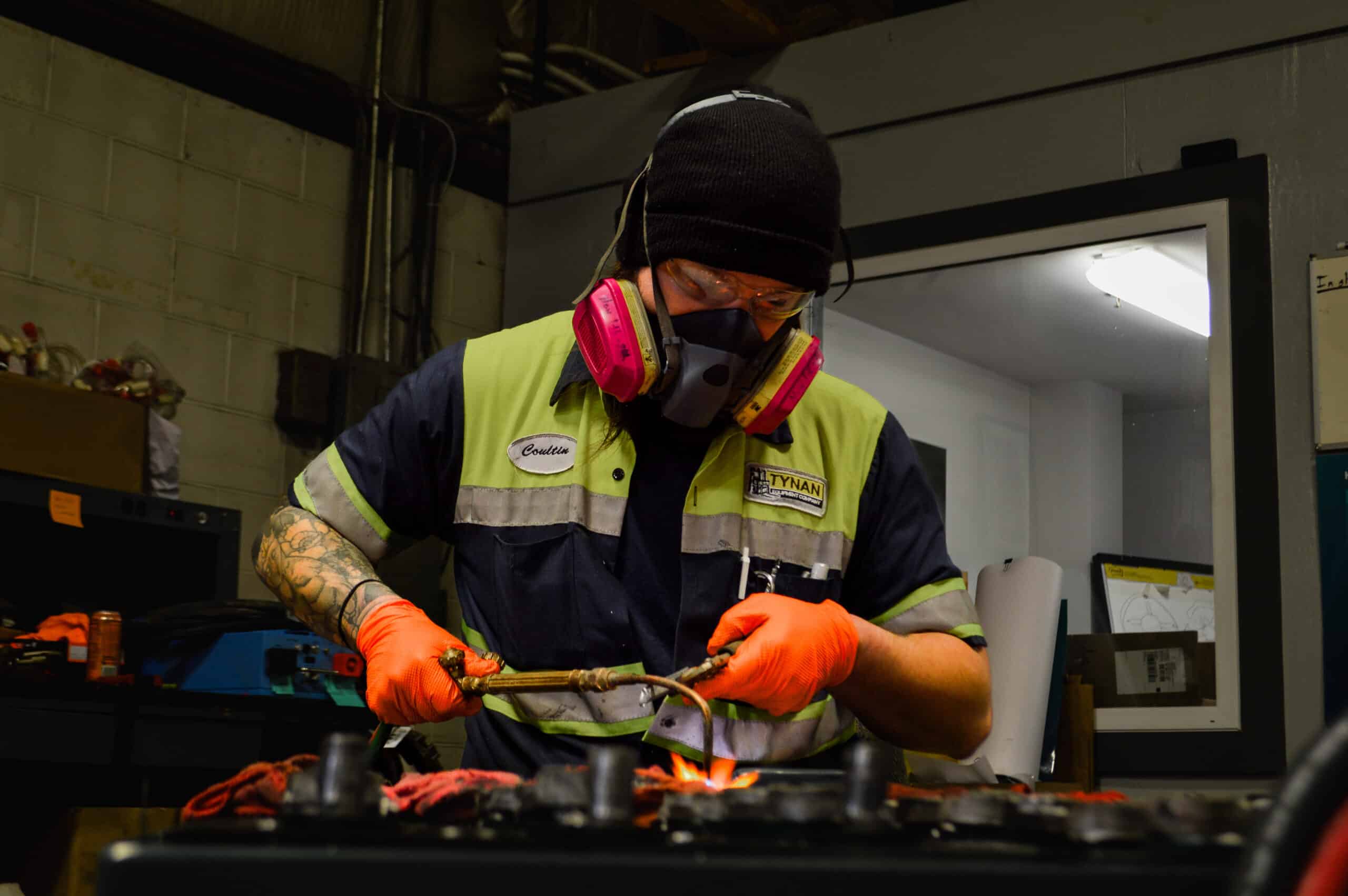 Image of a Tynan employee servicing a piece of equipment